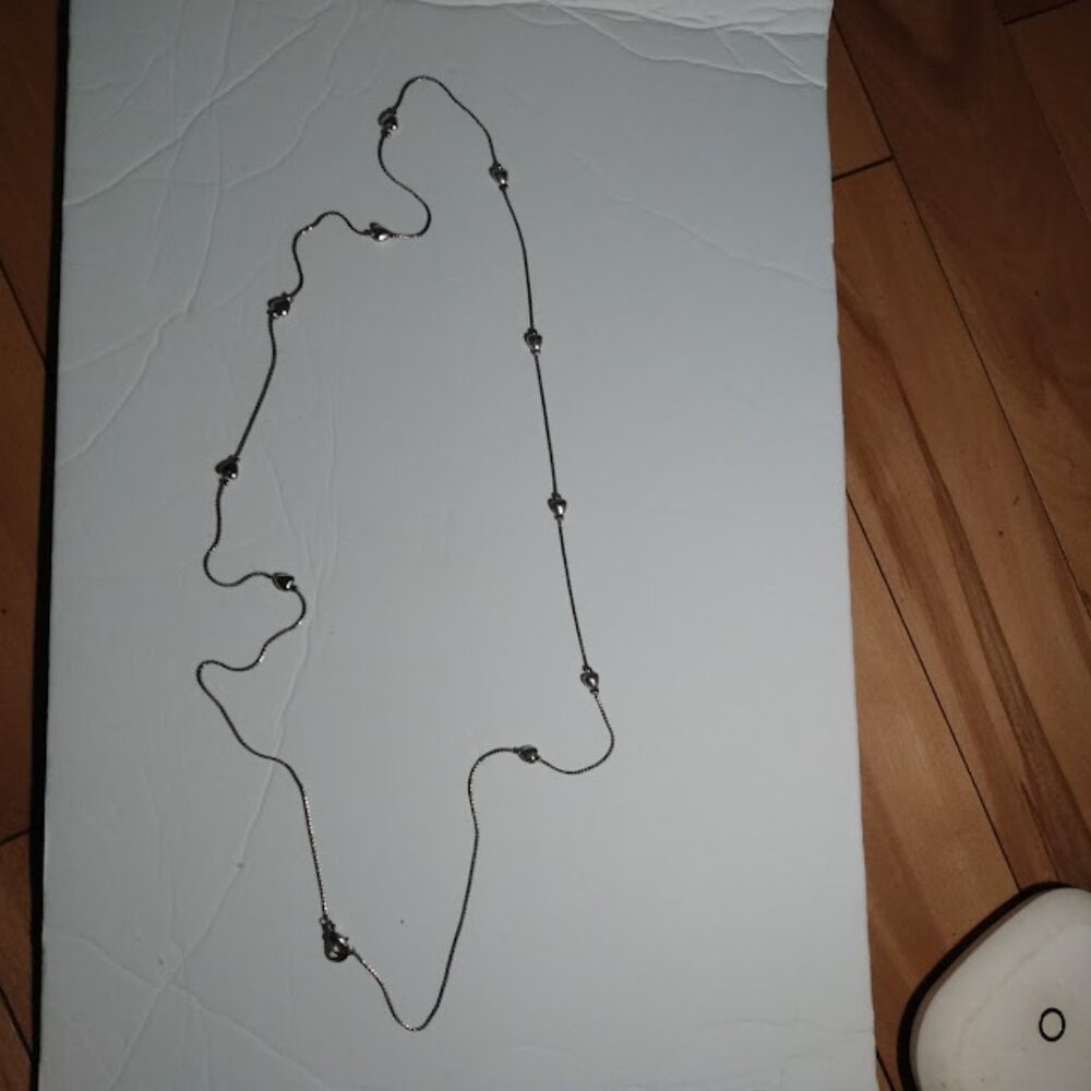 Silver tone chain necklace with hearts.